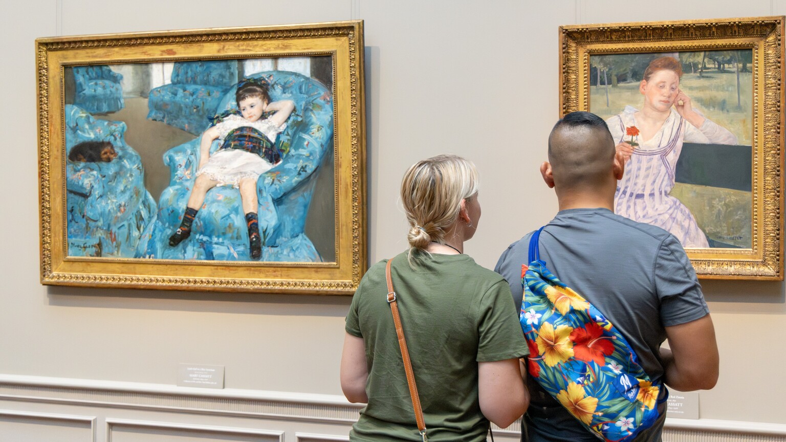 Visitors looking at a painting in the National Gallery of Art.