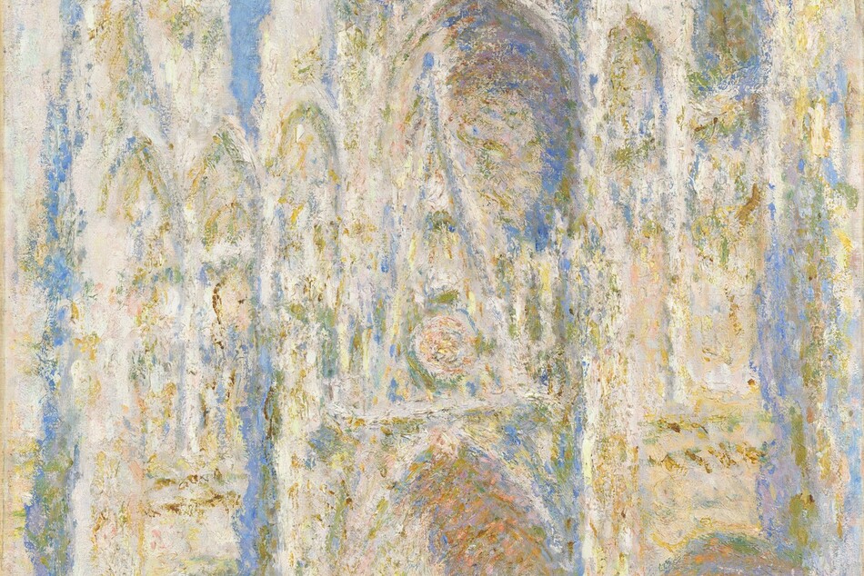 We look up at the exterior of a church that soars the height of this vertical painting. The church is painted with visible dabs and strokes of sky blue, cream white, golden tan, and a few touches of pale, shell pink to create a blurred look, as if seeing a reflection in the rippling surface of a puddle. The church façade is angled to our left, away from us. The main door and its surround takes up the center of the composition, where a rectangular door is set within nested, pointed arches that lead up to a narrow, tall, triangular gable. The point of that gable overlaps the round rose window, which is the same width as the portal surround below. Spires flank the central section and rise steeply off the top edge of the painting. The sky above is painted as a field of pale lapis blue. A few dabs of darker blue and green suggest people, tiny in scale, standing near the lower left corner. The artist signed and dated the lower right, “Claude Monet ‘94.”