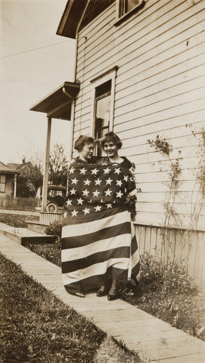 Untitled (Two women wrapped in American flag)
