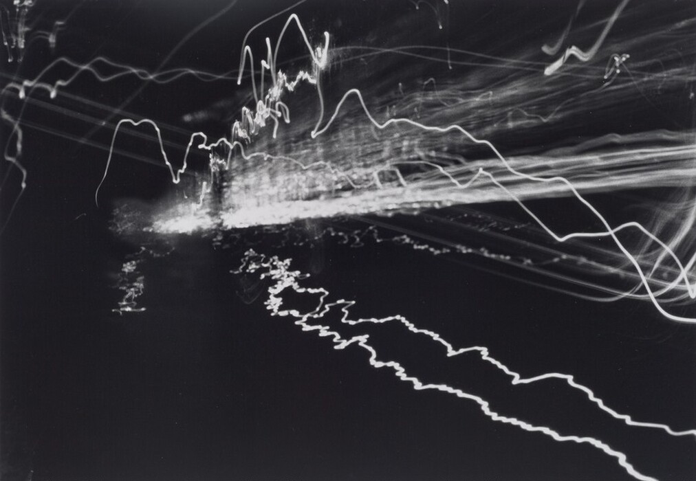 The image displays white squiggly lines on a dark background, which intersect to form an abstract pattern.