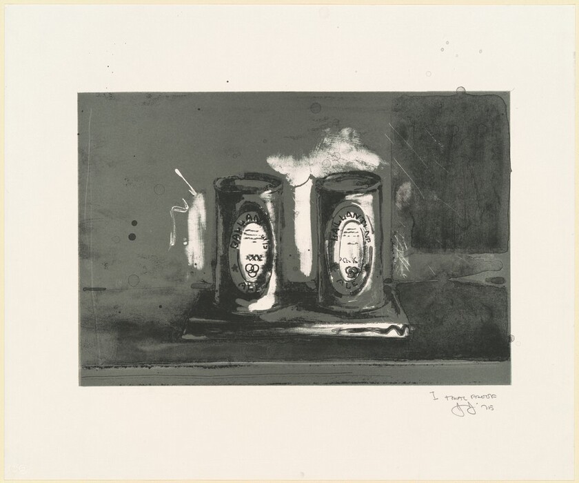 The image contains two cylindrical objects on a rectangular surface. The objects are centrally positioned, slightly right of center with labels facing forward. The color scheme is grayscale with abstract markings on the left side and a darker textured area on the right.