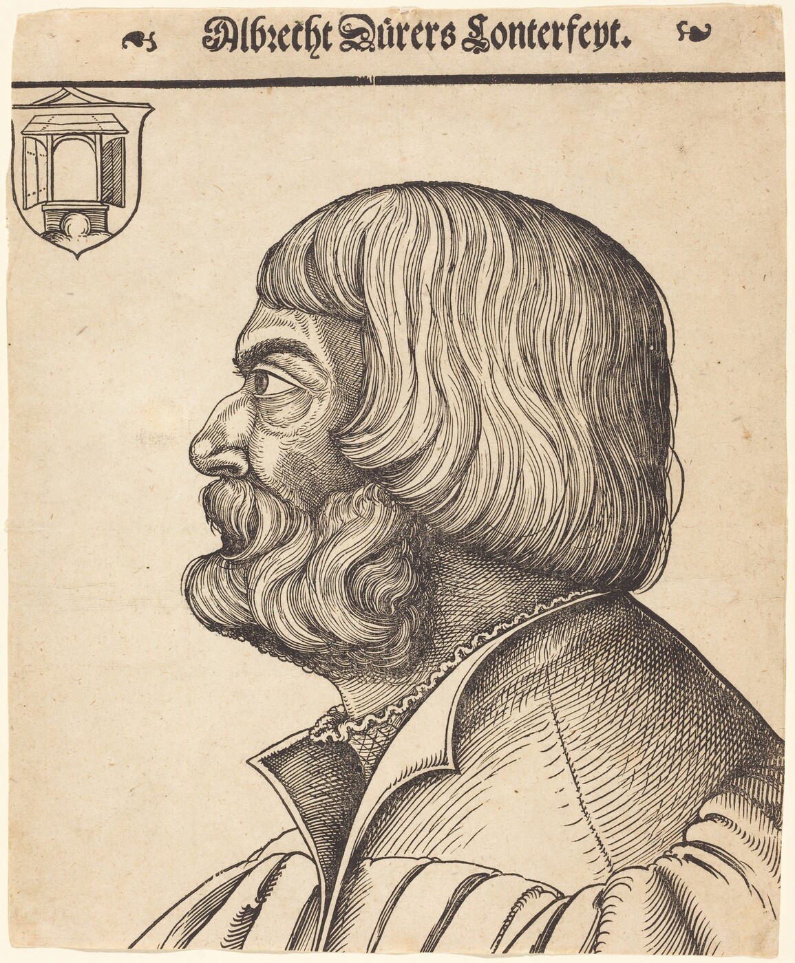 The image shows a profile view of the upper half of a man, facing left. He is depicted in a seated position with his head turned to the side. The man has strong, defined features with a prominent nose and a thick, full beard and mustache. His hair is styled in a straight, shoulder-length cut with a center parting. He is wearing a garment with a wide, rounded collar and visible stitching. The background is plain and features a coat of arms at the top left corner with architectural elements and stylized text “Albrecht Dürers Contrefeyt” above the figure.