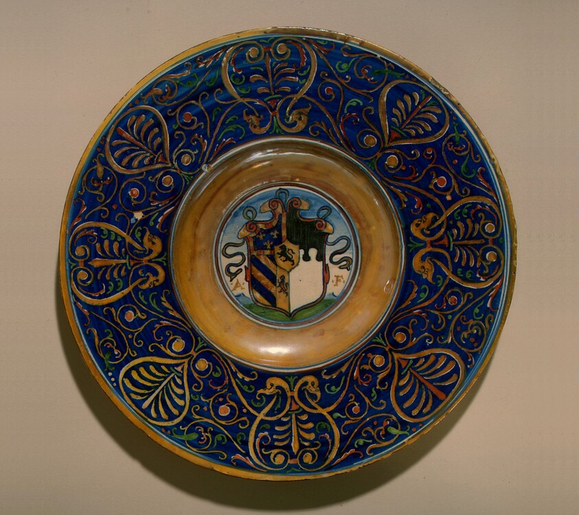 Plate with border of palmettes and scrollwork; in the center, a shield of arms and the initials A.F.