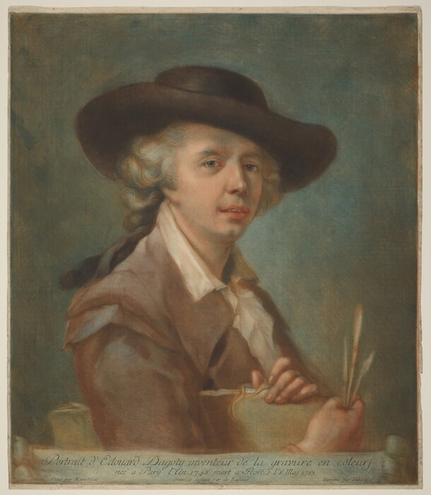 The image features a person sitting in a three-quarter position, facing slightly to the right and looking at the viewer. The individual has light skin and curly light-colored hair under a wide-brimmed brown hat. They wear a brown coat over a white shirt with a distinctive collar. The person holds quills in one hand. The background is a muted greenish tone with a textured appearance, and there is no visible jewelry on the person.