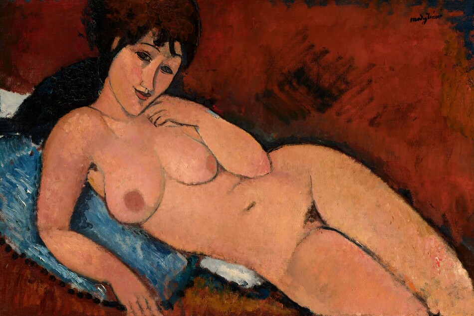 A nude woman with long, dark brown hair and peach-colored skin reclines against a denim-blue cushion in this stylized, horizontal painting. The painting is done mostly with areas of mottled color outlined in delicate black lines. Shown from the knees up, the woman lies with her legs to our right, and her hips tipped forward so her body faces us. She looks at us with dark, almond-shaped eyes under thin, arched brows. Bangs gather across her forehead, and her dark hair seems to be pulled back. Her head is tipped to our right, and she has an upturned nose, smooth cheeks, a pointed chin, and her smiling coral-red lips are closed. She holds the back of her left hand to her cheek and props herself up on her other elbow. Her rounded breasts have rust orange-colored nipples, and the contours of her body are smooth. There is a patch of dark hair at her groin, and her legs are pressed together. The blue pillow she rests on overlaps a white cloth or second pillow. The rest of the background is painted a terracotta brown with loose brushstrokes, so the setting is undefined. The artist signed the painting in dark letters in the upper right corner: “modigliani.”