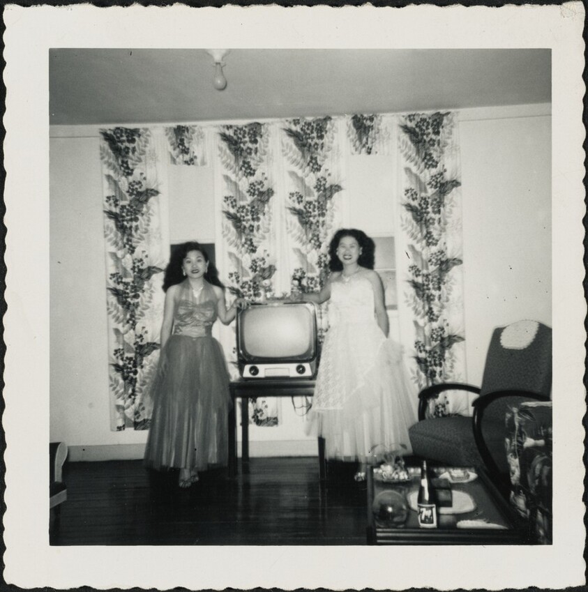 Untitled (Two women in gowns in front of television)