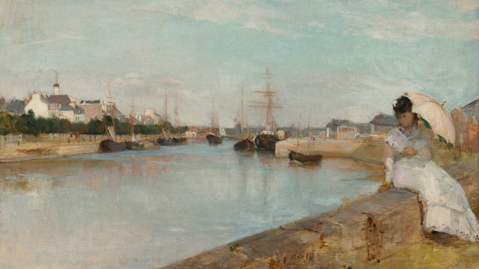 From behind a low stone wall, on which a young woman with pale skin sits, we look across a wide, shimmering blue waterway toward a town along the opposite shore, under a pale blue sky with wispy white clouds in this horizontal landscape painting. The caramel-brown, stone wall runs across the lower right corner, into the distance to our right. The woman sits on our side of the wall with her legs angled to our right, and she twists to lean onto her right hand, on our left, as she looks down toward the water. Her brown hair and face are shaded by the pale, shell-pink umbrella she holds in her left hand, to our right. She wears an ankle-length white dress with long sleeves, and a touch of white on the black hat she wears suggests it is decorated with a flower. The waterway seems to be lined with smooth walls like a canal. Ships with black hulls and wooden masts nearly span the passageway and reflect in the surface of the water beyond the woman. The shore across from us is lined with a row of deep green trees in front of a cluster of cream-white buildings with charcoal-gray roofs. More buildings are visible in the distance on our side of the waterway. The scene is loosely painted so many details are difficult to make out, especially in the woman’s face. The artist signed the work in dark paint at the lower center: “B Morisot.”
