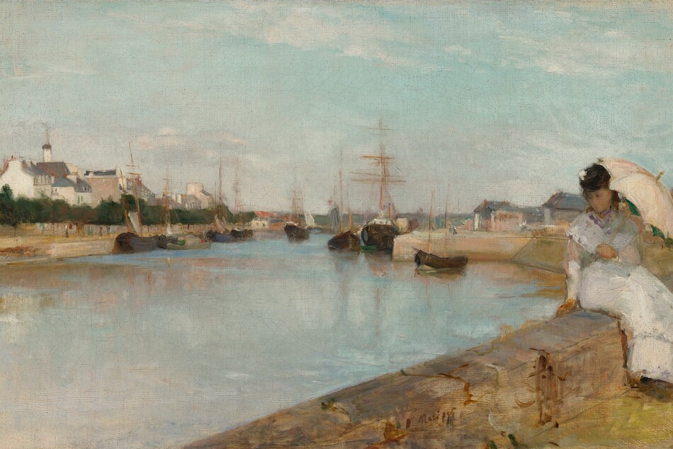 From behind a low stone wall, on which a young woman with pale skin sits, we look across a wide, shimmering blue waterway toward a town along the opposite shore, under a pale blue sky with wispy white clouds in this horizontal landscape painting. The caramel-brown, stone wall runs across the lower right corner, into the distance to our right. The woman sits on our side of the wall with her legs angled to our right, and she twists to lean onto her right hand, on our left, as she looks down toward the water. Her brown hair and face are shaded by the pale, shell-pink umbrella she holds in her left hand, to our right. She wears an ankle-length white dress with long sleeves, and a touch of white on the black hat she wears suggests it is decorated with a flower. The waterway seems to be lined with smooth walls like a canal. Ships with black hulls and wooden masts nearly span the passageway and reflect in the surface of the water beyond the woman. The shore across from us is lined with a row of deep green trees in front of a cluster of cream-white buildings with charcoal-gray roofs. More buildings are visible in the distance on our side of the waterway. The scene is loosely painted so many details are difficult to make out, especially in the woman’s face. The artist signed the work in dark paint at the lower center: “B Morisot.”