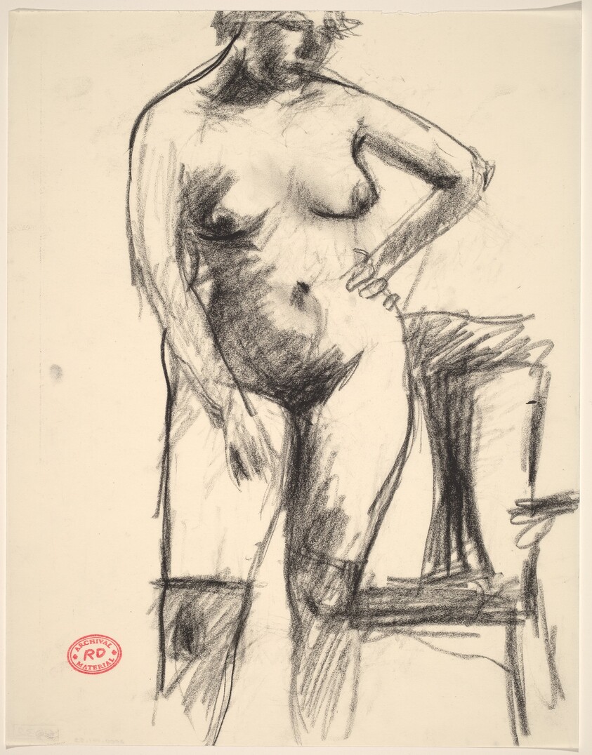 Untitled [nude in black stockings standing before an armchair]