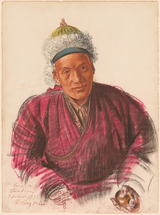 The image depicts the upper half of a seated person. The individual is slightly turned towards the viewer, holding a round object and a rosary over the wrist. They have curly white hair, a green hat with a yellow and red top, and wear a dark red and burgundy traditional garment. The person's facial features include pronounced cheeks, a straight nose, and a calm expression with slightly downturned eyes. The background is plain and light-colored.