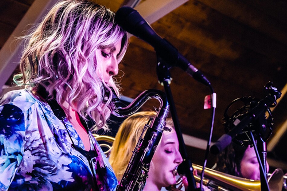 A woman playing the saxophone.