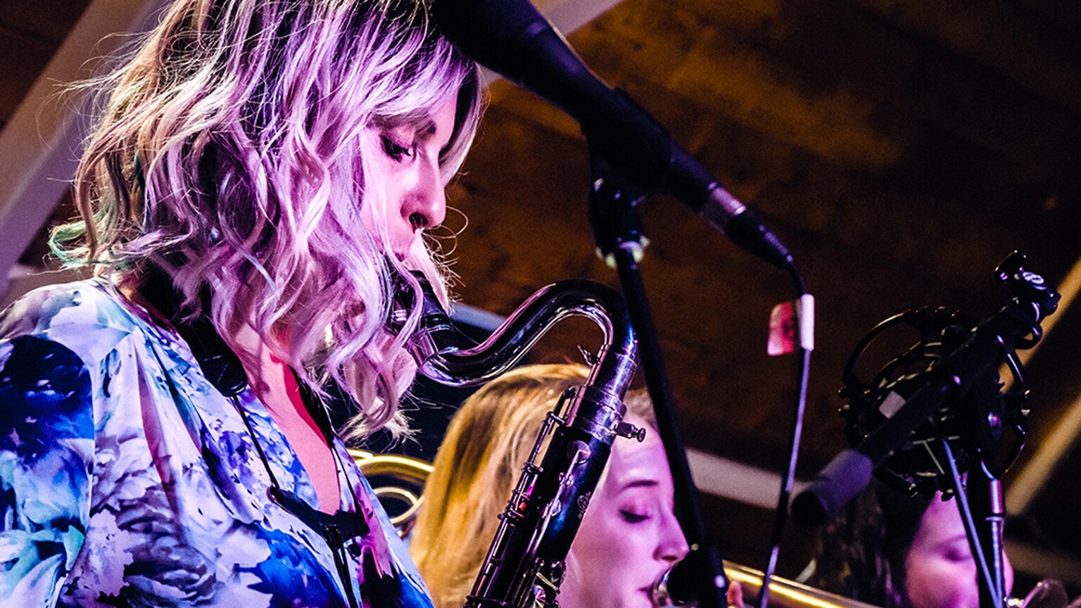 A woman playing the saxophone.