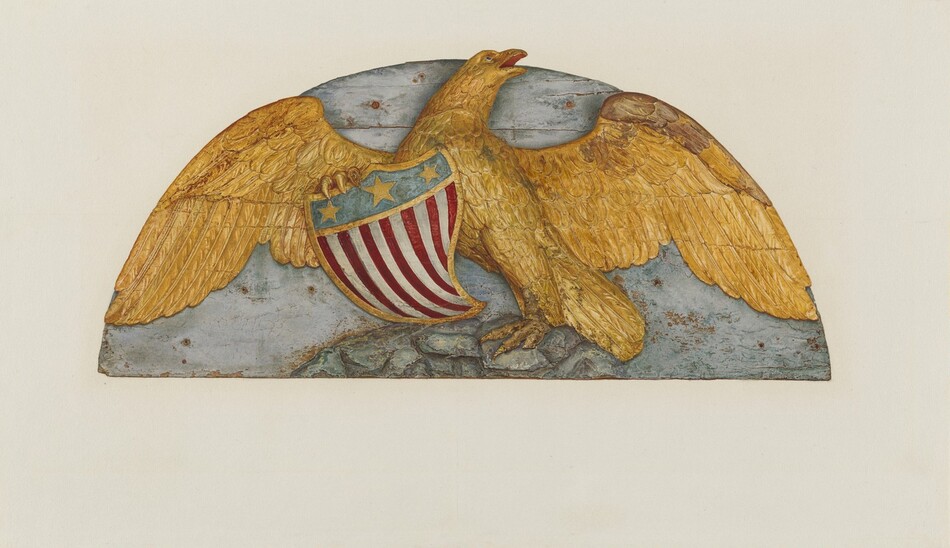 The sculpture depicts a stylized eagle with spread wings. The eagle is colored in golden hue and crafted from what seems to be wooden material. It holds a shield with a blue top featuring stars and red and white stripes. The wings are wide against a neutral background. The sculpture showcases intricate details highlighting the texture of feathers and the eagle's posture.