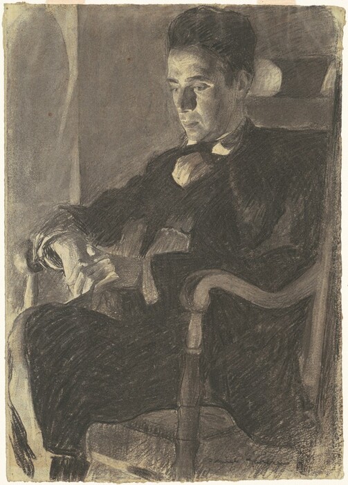 The image shows a man seated in a chair, from the waist up. He appears relaxed, with his legs slightly crossed and arms resting on the chair's armrest. The man has well-defined facial features with a contemplative expression, dark slicked-back hair, and wears a formal outfit. His hands are interlocked, and he gazes forward. The background is a muted, dark shade, emphasizing the man's face and outfit. The lighting creates a dramatic contrast, highlighting specific areas of his clothing and face.