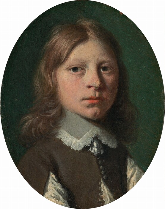 The head and shoulders of a young, pale-skinned boy fill this oval portrait painting. His shoulders are angled to our right, but he turns his face to look at us out of the corners of his large, dark blue eyes. His round cheeks and nose are slightly flushed, and his full, pink lips are closed over a cleft chin. His wavy brown hair falls to his shoulders and around his high, lace-edged collar. The boy’s brown doublet has small buttons down the front, which falls open over a linen shirt. His sleeves are also slit almost up to the shoulders to reveal linen there, too. Light from high to our left falls across the boy’s face and casts the ocean-green background into shadow.
