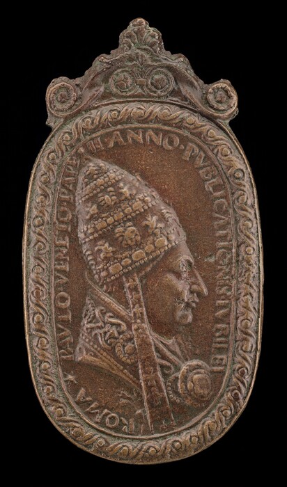 The relief carving depicts a papal figure in profile view wearing a detailed papal tiara with multiple tiers and intricate decorations. The figure is dressed in traditional papal vestments, and the surrounding border features ornate floral carvings and Latin inscriptions. The material appears to be a weathered, aged metal with a brown and green patina, suggesting bronze or a similar alloy, with a textured surface. The sculpture is encased in an oval frame with a decorative finial at the top. The overall appearance suggests it is meant for commemoration or veneration, capturing the likeness of the subject with attention to detail.