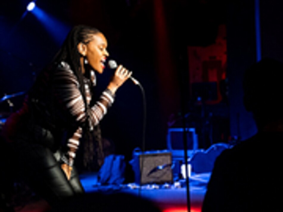 A woman singing into a microphone.