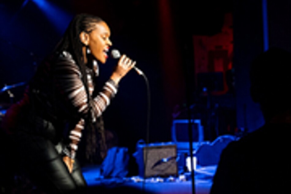 A woman singing into a microphone.