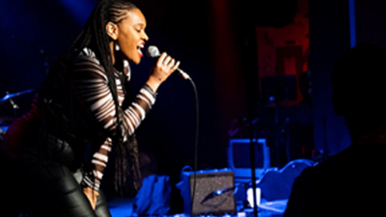A woman singing into a microphone.