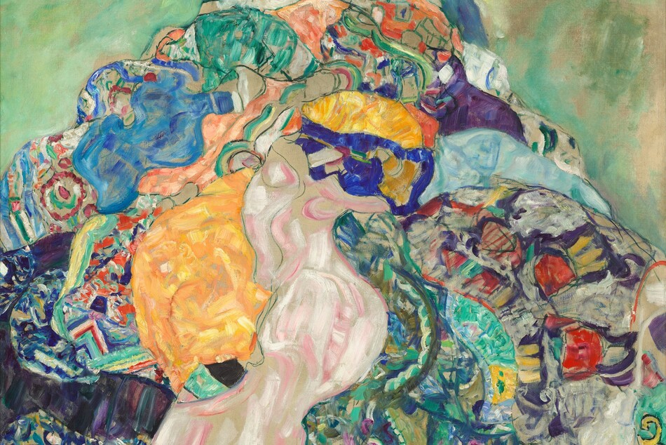 A baby nestles in a mass of frilly white fabric atop a colorful patchwork, perhaps a pile of quilts, against a sage and spring-green background in this square painting. The baby’s face and right hand peeks out from the mountain of fabric at the top center of the composition. The infant has ash-white skin with pink cheeks and lips, and looks down toward us with large dark eyes. The pile of fabric creates a mosaic-like mix of pattern and color with vibrant royal and baby blue, sage green, turquoise, butter yellow, and shell and salmon pink. Some patterns are outlined in black while brushstrokes swirl together in other areas. The background is mottled with cool mint and asparagus-green strokes against pale beige.