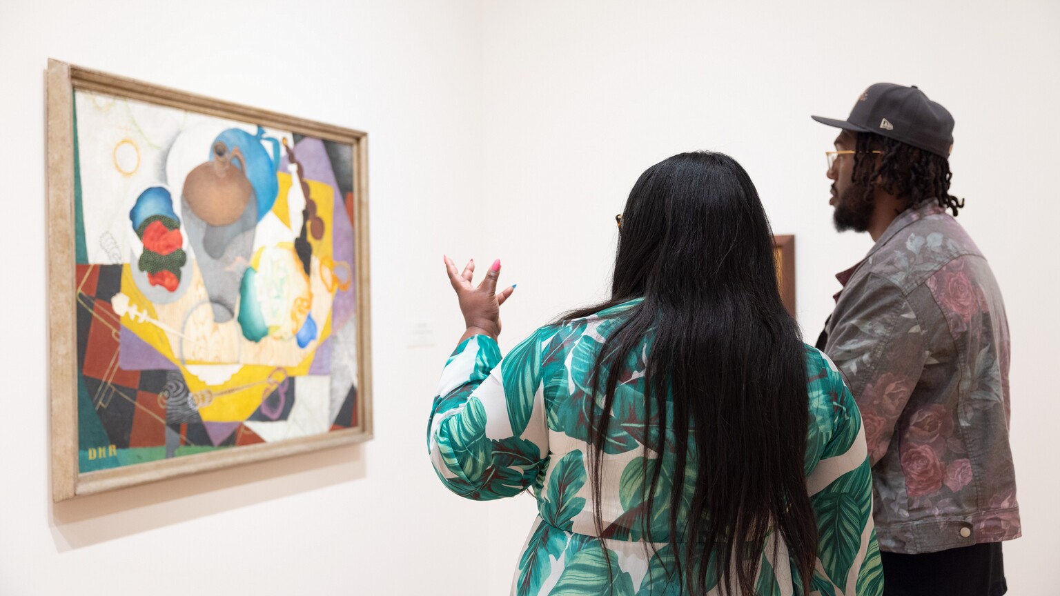 Visitors look at a painting in the National Gallery of Art. 