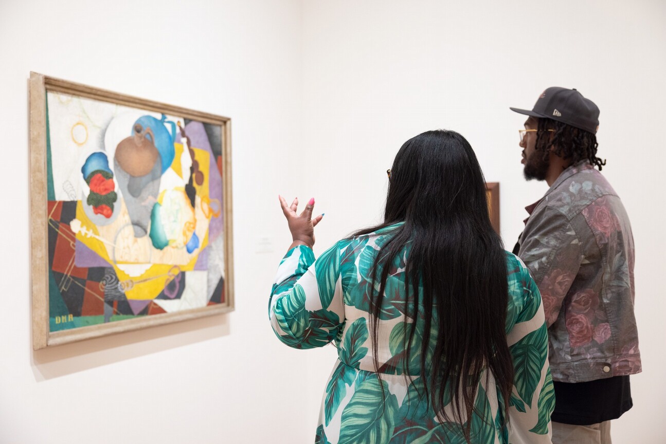 Visitors look at a painting in the National Gallery of Art.