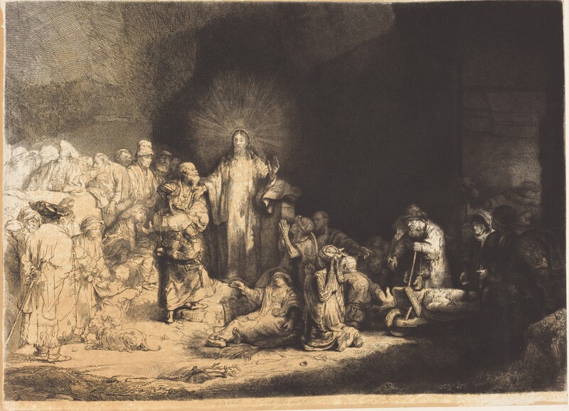 Printed with black lines and deep, velvety shading on tan-colored paper, a man, Jesus, stands at the center of a crowd of more than two dozen people, mostly adults and a few children, in this horizontal etching and drypoint. Jesus is left of center. He stands facing us, but he turns his head to look to our left. Rays of light emanate from behind his head against the towering cave opening that swallows the right two-thirds of the scene. Jesus’s curly hair falls long over his shoulders, and he holds both hands out. His eyes are lightly incised, giving them an almost blurred look. A crowd of people lie or kneel deep in shadow to our right. Some use crutches or walking sticks, and some are on carts. All the people appear to have pale skin except for one with darker-toned skin to the right in this gathering. That person has a rounded nose, full lips, and wears an earring that gleams brightly in the deep shadows. A camel stands at the far side of this group under an arched opening. The people standing and one person sitting close to Jesus to the left are fully shaded, and those farther left are lightly outlined and sparsely shaded so they appear to be much lighter on the white paper. Close to Jesus are a woman holding a baby, a seated, clean-shaven young man, and several bearded men. Most of those who are along the left edge of the sheet wear turbans or floppy caps.