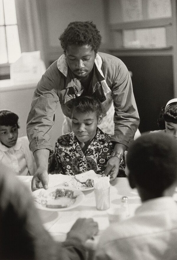 Black Panther Charles Bursey serving food to girl, St. Augustine’s Episcopal Church
