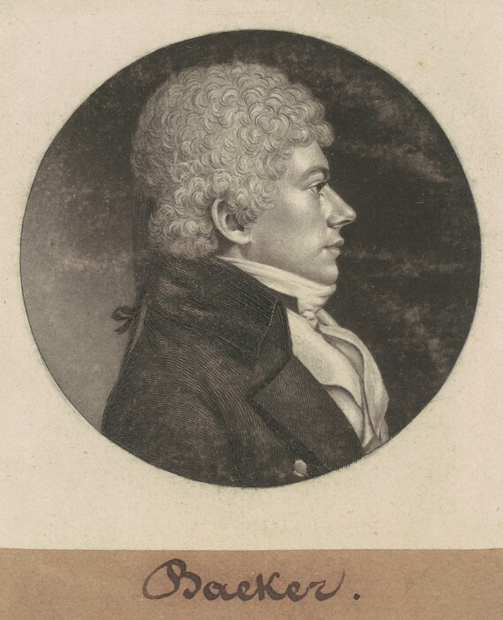 The image shows a profile of a man from the chest up, in a seated or standing position facing to the right. The man has tightly curled hair, a pronounced nose, and a firm jawline. He is dressed in formal attire, wearing a dark jacket with a high collar and a white cravat. There are no visible accessories such as jewelry. The background is a simple, dark circular vignette.