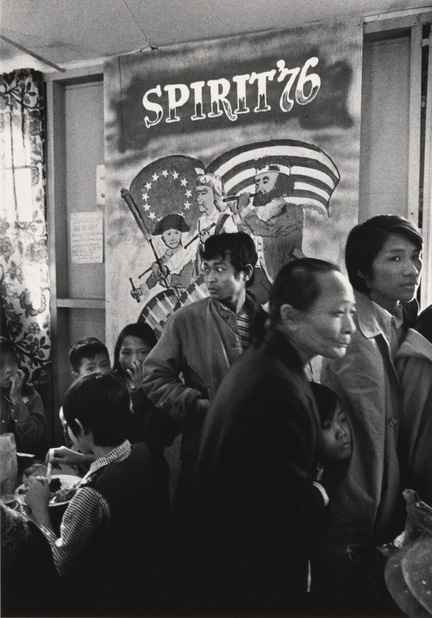 Refugees in mess hall waiting for meal