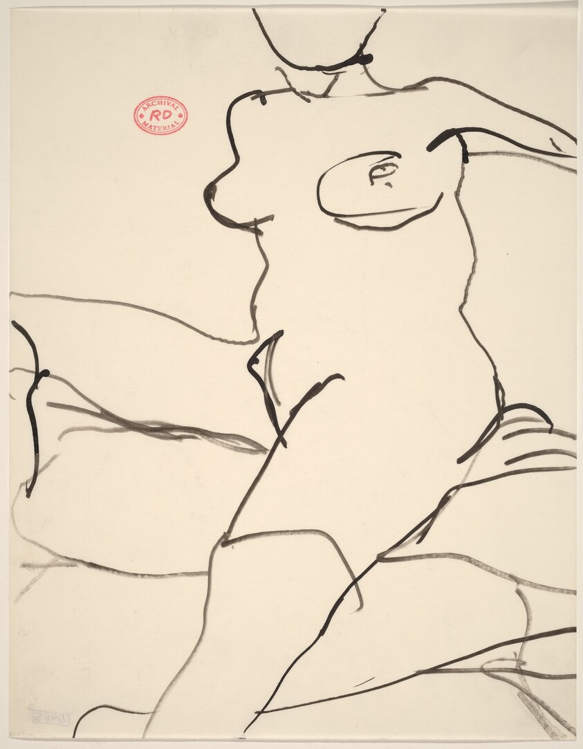 Untitled [female nude seated on cushions]