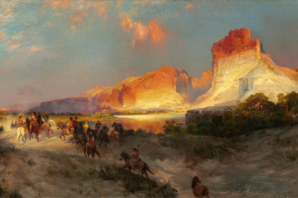 Sheer, vertical, cliffs, brightly lit in cream white and rust orange by the low sun, tower over a band of people riding horses into the distance in this long, horizontal landscape painting. The glowing cliffs dominate the upper right quadrant of the painting. They lighten from burnt orange along the jagged tops to flame orange down the steep sides, and are and warm, parchment white near the earth. One tall, narrow promontory to our right looms over a range of lower, rounded cliffs. As the cliffs move into the distance, they are shrouded with a lavender-purple haze. The land closest to us dips into a shallow valley at the bottom center of the composition, leading away from us. The dirt-packed earth is dotted with pine-green, scrubby bushes and vegetation and a grove of low, gnarled trees a short distance to our right. One chestnut-brown horse walks along the path at the bottom center of the composition, lagging behind a cluster of at least two dozen horses and riders winding into the distance. The horses range from ivory white to tawny brown and charcoal gray. The riders are loosely painted so some details are indistinct, but they all seem to have brown skin and dark hair. They wear feathered headdresses and garments in teal blue, fawn brown, or golden yellow. They ride over a low hill toward a crystal-blue river, and then back along a flat expanse toward a row of minuscule, triangular tepees lining the horizon in the deep distance. The horizon comes halfway up the composition, and the tepees are backed by a row of rose-pink, flat-topped cliffs. A pale yellow disk hangs low in the sky, over the distant cliffs. The sky above deepens from soft, lilac purple along the horizon to ice and sapphire blue along the top. A few wispy clouds are burnished orange in the sunlight. The artist signed and dated the painting in the lower right corner, “TYMoran 1881,” with the T, Y, and M overlapping to make a monogram.