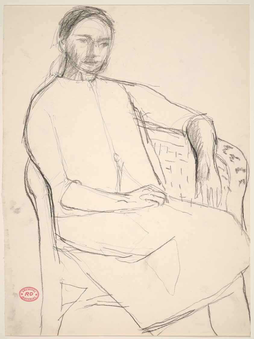 Untitled [woman seated in a wicker chair]