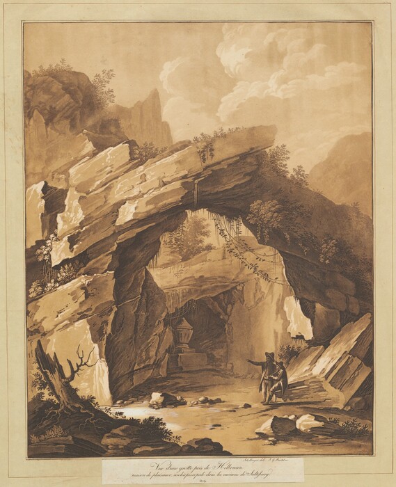 The image shows a natural rock archway with foliage growing on it. In the foreground there are rocks and sparse vegetation. A small urn is seen under the archway, and a cloaked figure is pointing towards the scene. The rocks and foliage are depicted in shades of brown, with darker tones for shadows and lighter tones for sunlit areas. The background displays more rocks reaching up to a sky with a few clouds. The color scheme is primarily earthy browns, giving the image an antique look.