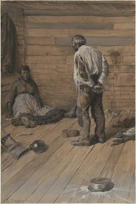 The image depicts two individuals within a wooden cabin-like room with no windows. The person on the left is sitting on the floor against a wall, with only the upper half of their body visible. The person on the right is standing with their back slightly to the viewer, displaying their full height, and they are bent slightly forward towards the sitting person. The floor is wooden, with several objects scattered around, including a tipped-over chair, a jug, and a metal bowl on the floor. A coat or jacket is hanging on the wall behind the seated person. The walls are made of horizontal wooden planks.