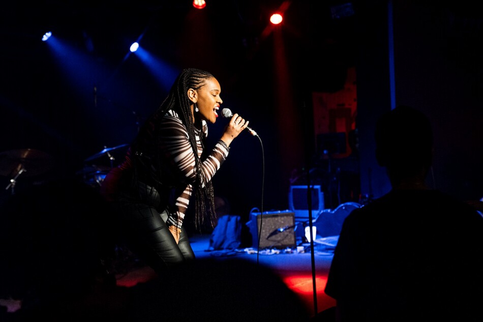 A woman singing into a microphone.