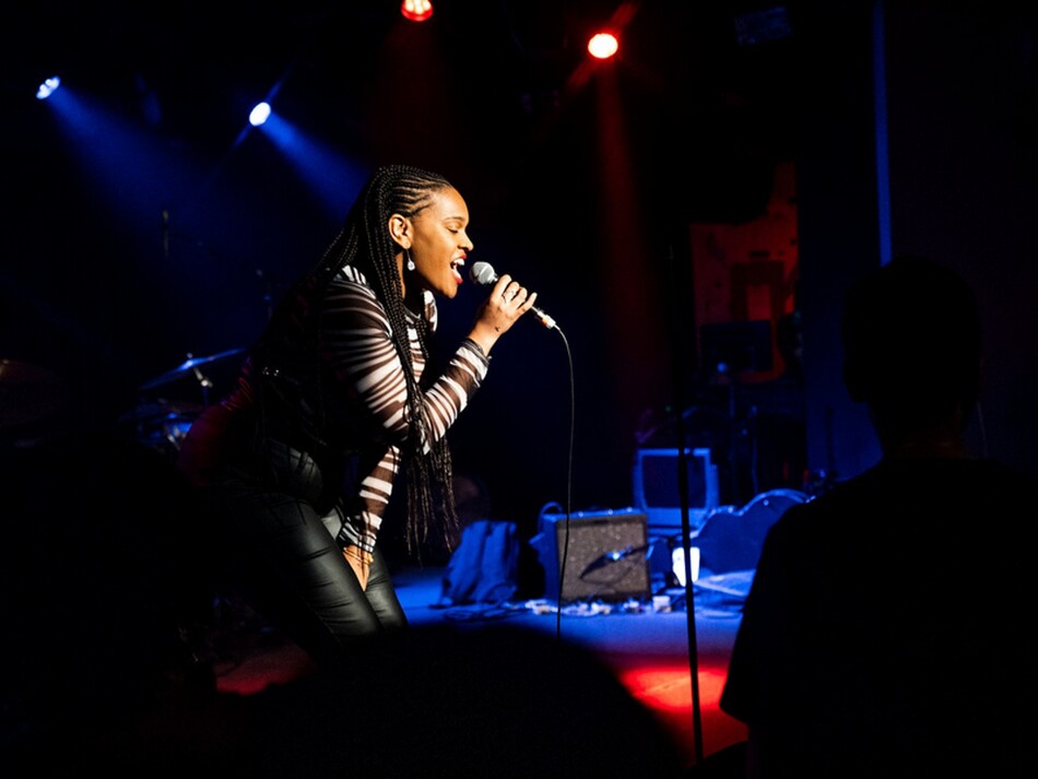 A woman singing into a microphone.