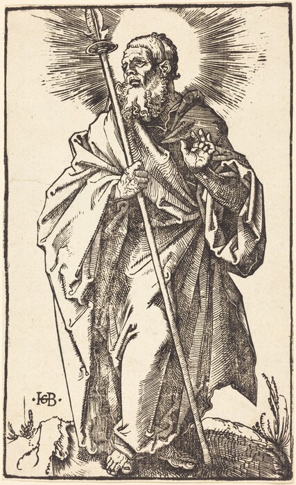 The image shows a man standing and holding a large staff in his left hand. His right hand is raised, and he is looking upwards. The man has a long beard and mustache, short curly hair, and is wearing a flowing robe. He is barefoot, and there are some plants and rocks near his feet. A halo-like radiance appears behind his head. The background is plain.