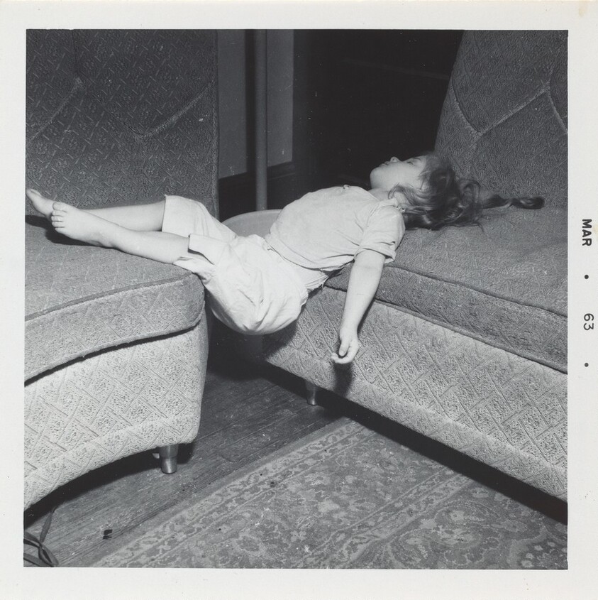 Untitled (Girl lying across two couches)