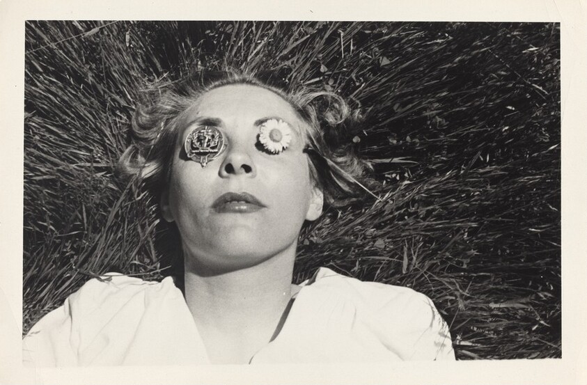 Untitled (Woman lying in grass with metal objects over eyes)