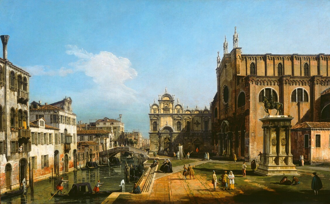 People walk, sit, or stand on a plaza along a canal lined on the far side with buildings in this horizontal landscape painting. The canal begins in the lower left corner and angles slightly right as it travels to the horizon, which comes about a third of the way up this composition. One, two, three, or four-story buildings line the canal to the left into the far distance. Arched doorways give direct access to the water, and one person leans out an upper-story window. The buildings are reflected in the gently rippling water, which is painted in shades of olive green. A stepped bridge crosses the canal in the near distance, and two gondoliers guide a long, narrow boat to a platform alongside the plaza in the bottom left corner of the composition. People walk or stand singly or in pairs on the plaza in the bottom right quadrant of the painting. The women wear dresses with long skirts and head coverings in shades of black, white, yellow, or pale pink. The men wear hats, jackets, capes, stockings, and slacks in shades of peanut brown, muted yellow, red, blue, or white. The people all appear to have pale, peachy skin. A statue of a man riding a horse rests on a towering platform in a grassy patch to our right. Beyond it is the blocky form of a red brick church. One man in a pair standing on the plaza gestures toward the entrance with a walking stick and others approach the central entrance. Sunlight streams across the scene from the upper right, throwing the church façade into shadow and casting a deep shadow across the face of another building that encloses the far side of the plaza. That second building has arched windows and doors, statues lining the roofline, and a winged lion over the entrance. A fat cloud trundles across a mostly empty vibrant blue sky above.