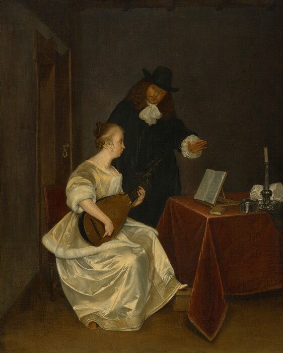 A woman wearing a pale yellow silk dress sits playing a lute in front of a table while a man, wearing a black suit and hat, stands behind her in this vertical painting. Both have light skin. The woman sits facing our right in profile as she looks at pages of sheet music propped on a wooden tabletop stand on the table in front of her. Her light brown hair is pulled back in a braid looped into a bun, and a few curly tendrils fall alongside her ears. She has a pointed nose, full cheeks, and a receding chin beneath closed lips. Light gleams off her pale, golden yellow jacket and skirt. The jacket has elbow-length sleeves and is lined with white fur, and her long skirt has a band of deep gold embroidery and possibly beading down the front and along the bottom hem. She rests one foot on a low wooden box, and the other is covered by her skirt. She sits in a straight-backed chair with a wine-red, upholstered back. The table in front of her, to our right, is covered with a burgundy-red cloth. Near the music stand are a small book with a brown cover, a silver, oval-shaped box, a silver candlestick holding a white, unlit candle, and a bunched up white cloth. Behind her, the man stands with his left hand, on our right, lifted over the sheet music. He tips his head forward to look down at the woman or her lute. He has thick, shoulder-length, wavy brown hair and a goatee. He wears a tall, brimmed, black hat, and there are ruffles of white fabric at his neck and the cuffs of his long sleeves. The room has a brown floor and smoke-gray walls. A door opens a little into the room to our left, behind the pair.