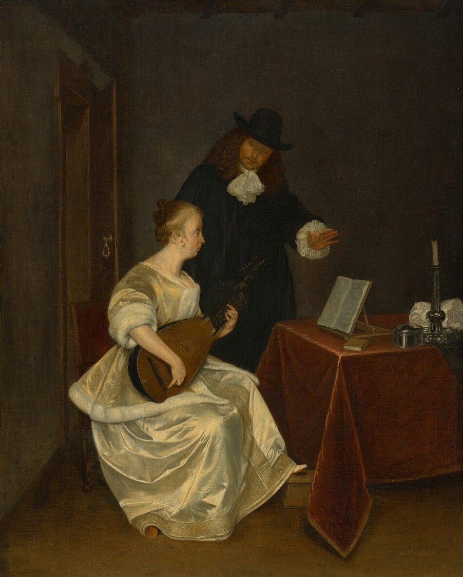 A woman wearing a pale yellow silk dress sits playing a lute in front of a table while a man, wearing a black suit and hat, stands behind her in this vertical painting. Both have light skin. The woman sits facing our right in profile as she looks at pages of sheet music propped on a wooden tabletop stand on the table in front of her. Her light brown hair is pulled back in a braid looped into a bun, and a few curly tendrils fall alongside her ears. She has a pointed nose, full cheeks, and a receding chin beneath closed lips. Light gleams off her pale, golden yellow jacket and skirt. The jacket has elbow-length sleeves and is lined with white fur, and her long skirt has a band of deep gold embroidery and possibly beading down the front and along the bottom hem. She rests one foot on a low wooden box, and the other is covered by her skirt. She sits in a straight-backed chair with a wine-red, upholstered back. The table in front of her, to our right, is covered with a burgundy-red cloth. Near the music stand are a small book with a brown cover, a silver, oval-shaped box, a silver candlestick holding a white, unlit candle, and a bunched up white cloth. Behind her, the man stands with his left hand, on our right, lifted over the sheet music. He tips his head forward to look down at the woman or her lute. He has thick, shoulder-length, wavy brown hair and a goatee. He wears a tall, brimmed, black hat, and there are ruffles of white fabric at his neck and the cuffs of his long sleeves. The room has a brown floor and smoke-gray walls. A door opens a little into the room to our left, behind the pair.