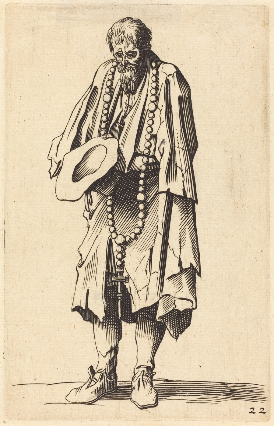 The image shows a full-length figure of a person standing and slightly hunched over. The individual is holding a hat in one hand and the other arm is hanging by their side. The person has a full beard and their hair appears somewhat unkempt and short. They are wearing a flowing garment, with layered clothing visible underneath. Around the person's neck hangs a long string of large beads with a cross attached at the end. The background is a plain, textured surface that keeps the focus on the individual.