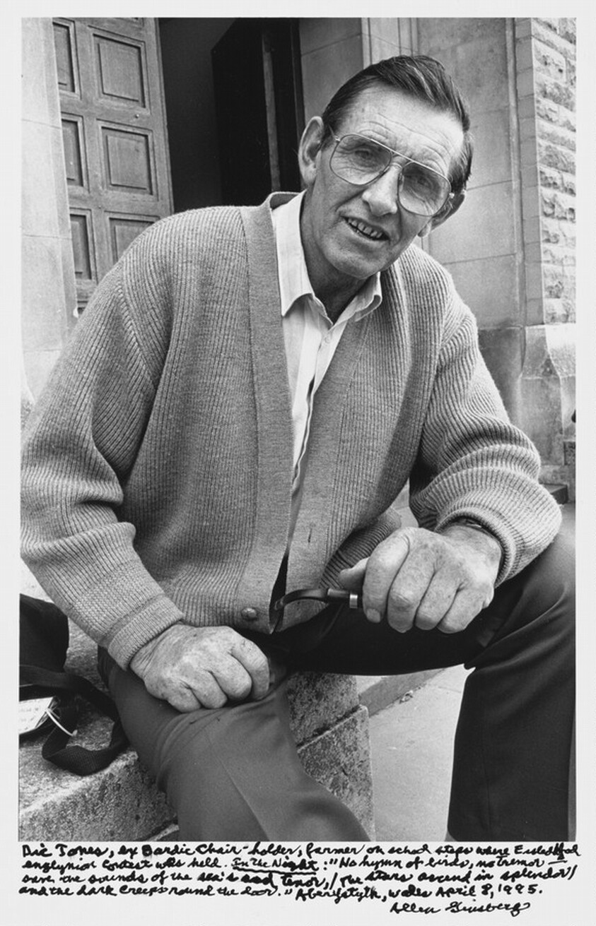 Dic Jones, ex Bardic Chair-holder, farmer on school steps where Eisteddfod Englynion contest was held. _In the Night_: "No hymn of birds, no Tremor -- save the sounds of the sea's sad tenor, / The stars ascend in splendor / and the dark creeps round the door." Aberystwyth, Wales April 8, 1995.