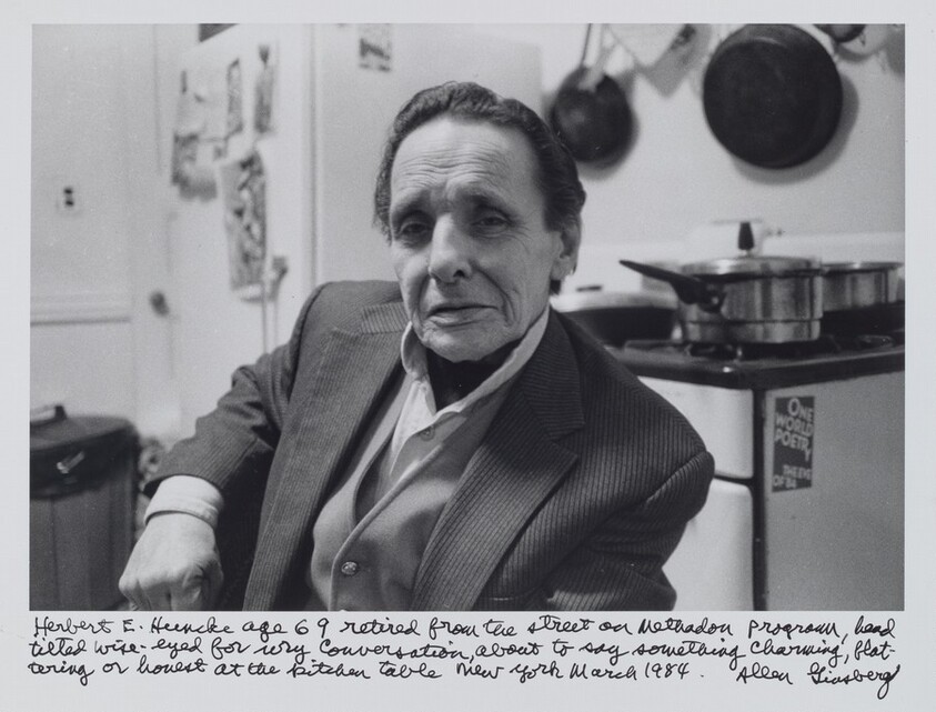 Herbert E. Huncke age 69 retired from the street on methadone program, head tilted wise-eyed for wry conversation, about to say something charming, flattering or honest at the kitchen table New York March 1984.