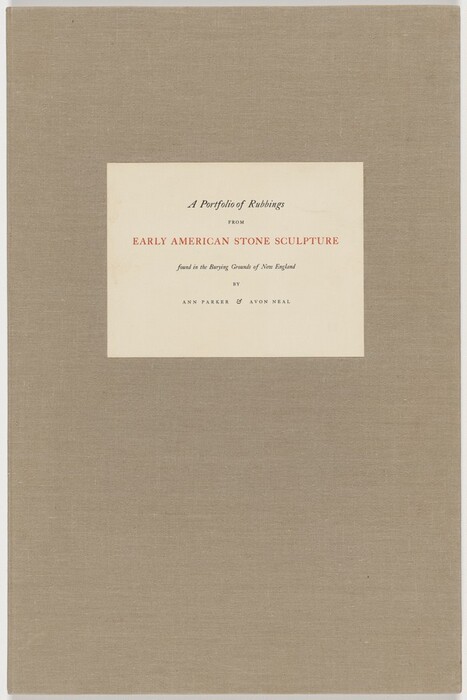 This is a photograph of a book cover. The cover is textured and made of a linen-like material in a beige or light brown color. In the center, there is a rectangular label with text. The text on the label is in serif fonts and arranged formally. It reads "A Portfolio of Rubbings" and "from Early American Stone Sculpture found in the Burying Grounds of New England by Ann Parker & Avon Neal." The title is in black ink, and the authors' names are in red ink against a cream background. The design suggests a scholarly or archival nature, potentially relating to historical or artistic content.