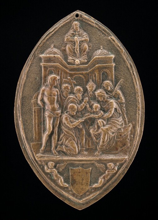 This is a bronze-colored, oval-shaped object. It features several people, including a kneeling man, five standing people, and a seated woman with a child in her lap. Many of the people are holding different objects, including a tall cross and what looks like a palm frond. Behind the group are architectural elements such as arches and two small domed roofs. Above this building, at the top of the oval, another person is sitting or floating above the central group. At the bottom is a shield with winged cherubs on either side.