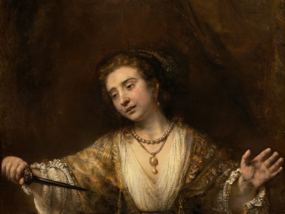 Shown from the thighs up, a pale-skinned woman looks down and off to our left as she holds the pointed end of a dagger toward her chest in this vertical painting. Her lips are slightly parted, and her arms are spread wide as holds the hilt of the dagger in her right hand, to our left. Her hooded, dark brown eyes are rimmed with red. Her head tilts to our left, her pale lips parted. There are gray shadows at the corners of her mouth and along her jawline. Her brown hair is pulled back under a cloth covering painted with white flecks to suggest shiny thread or possibly jewels. She wears a long, tawny-brown gown with diaphanous sleeves. The bodice is laced up over a cream-white undergarment with a deep V neck and voluminous sleeves with unfastened cuffs near her wrists. She wears a large, teardrop-shaped pearl in the ear we can see and two necklaces. One necklace is a strand of pearls, and the other is a gold and possibly jeweled pendant with another teardrop pearl hanging from a cord. A gold belt drapes around her hips over a narrow waist. She is warmly lit from the upper left and set against an earth-brown background. The artist signed and dated the center left, “Rembrandt 1664.”