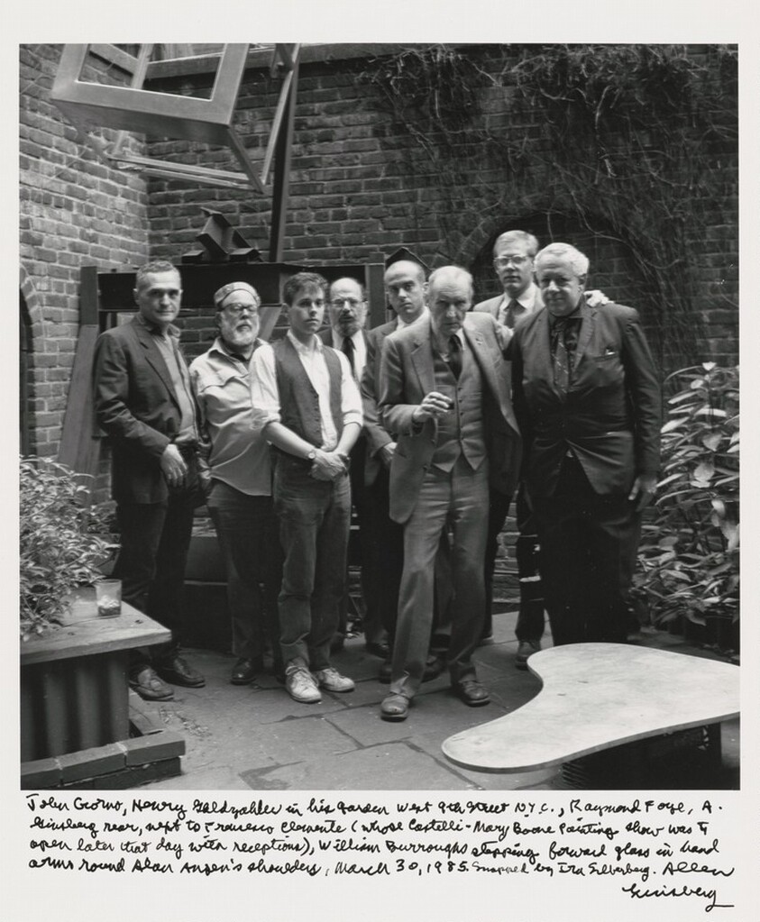 John Giorno, Henry Geldzahler, in his garden West 9th Street, N.Y.C., Raymond Foye, A. Ginsberg rear, next to Francesco Clemente  (whose Castelli - Mary Boone painting show was to open later that day with receptions), William Burroughs stepping forward glass in hand arms round Alan Ansen's shoulders, March 30, 1985. Snapped by Ira Silverberg. Allen Ginsberg